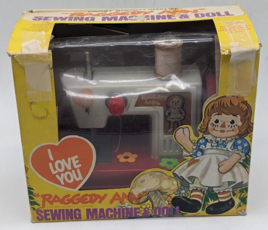 (L) Raggedy Ann sewing machine and doll in box