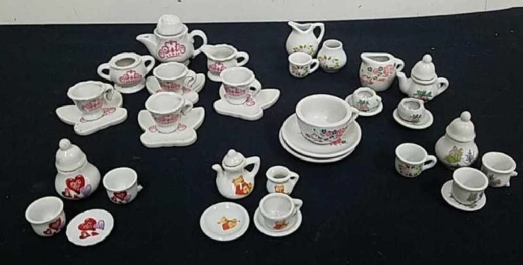 Seven partial miniature tea sets several Cups
