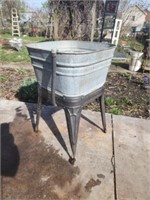Old galvanized wash tub on stand.