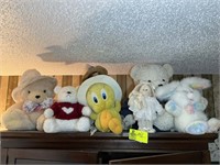 Group of stuffed animals including Tweety, bunny a