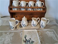 Shelf with mugs, cr, sugar, plates