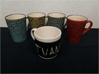 Four decorative coffee cups and one chalkboard