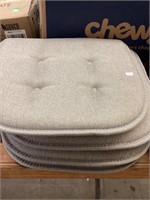 4 beige chair cushions