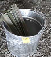 Galvanized bucket with army tent stakes