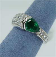 Platinum shaped emerald and diamond ring