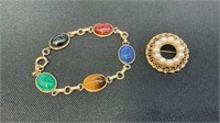 Gold tone scarab bracelet with multi colored