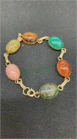 Gold tone scarab bracelet with multi colored