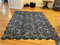 Full sized quilt with 2 black pillow cases and 2