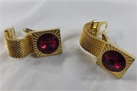 Golden wrap around cufflinks w/ red stone