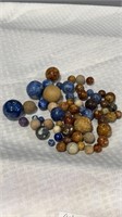 60 7/16” to 1 3/8” Bennington and clay marbles.