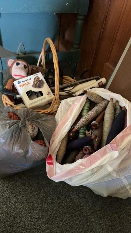 Bag filled with antique wooden bobbins with