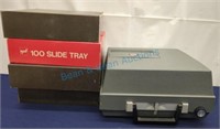 Slide projector and four empty trays