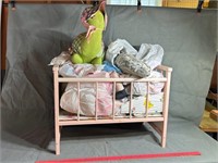 Doll crib with dolls and stuffed animals