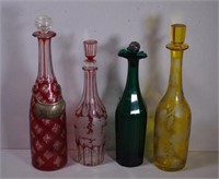 Four various early coloured glass decanters