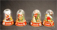 Four Coca Cola advertising Santa Claus figures