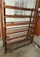 Six tier antique wooden shoe store rack on castrs