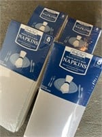 Four packages of new white cloth napkins