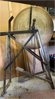 Antique grinding wheel, with a metal saddle seat,