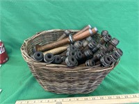 Antique basket full of antique wooden spools