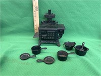Cast iron toy stove with pots and pans
