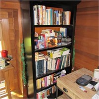 Contents of black bookcase loaded books & DVDS
