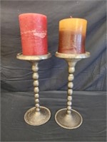 Pair of metal candle holders with candles