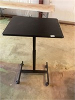 Black rolling adjustable table