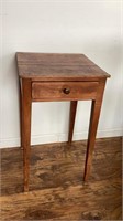 Pine table with one drawer, stick legs, brass