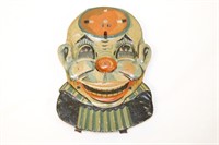 Early tin toy clown face