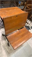 Antique cast-iron and wood school desk with a