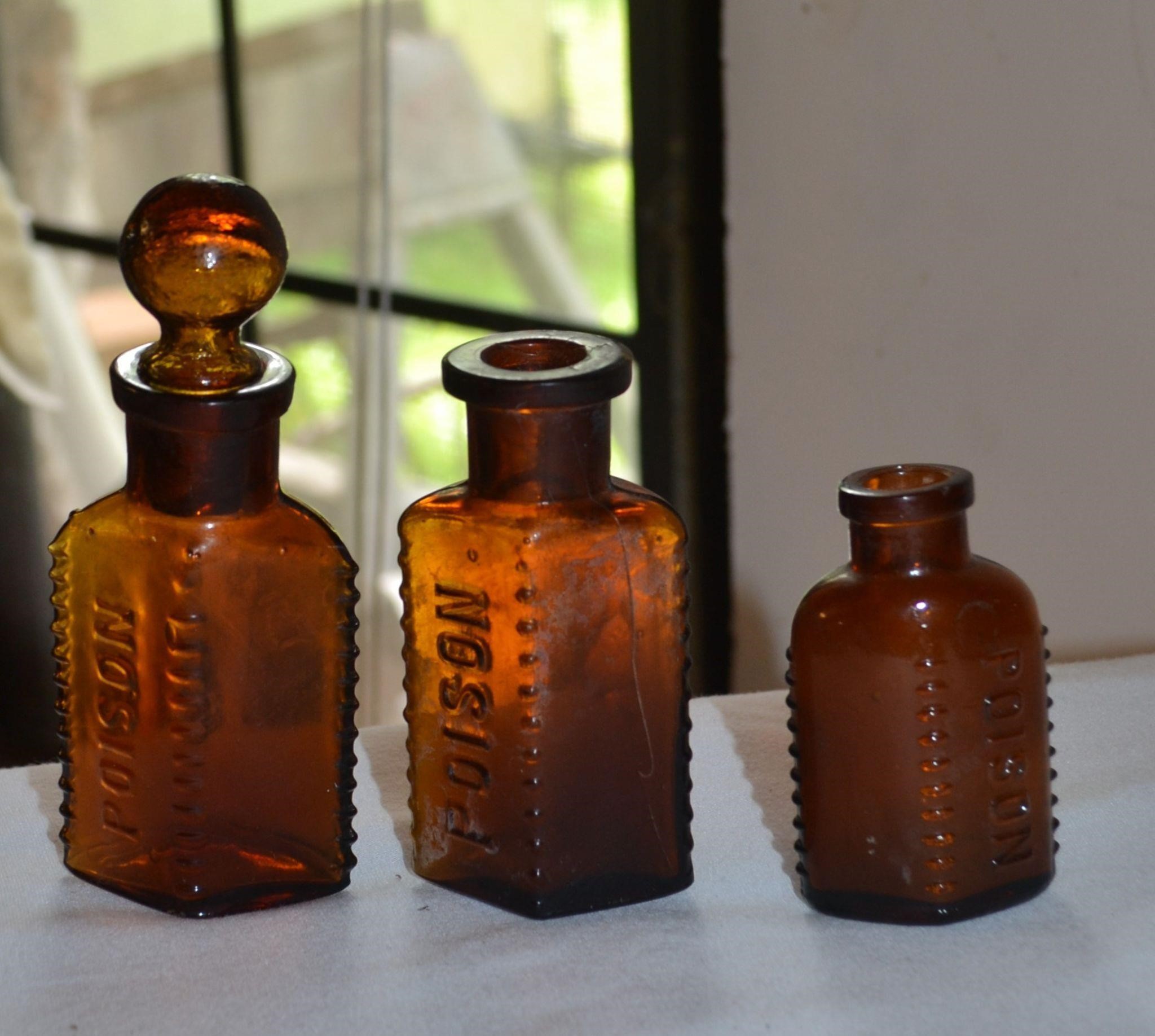 3 amber poisons bottles