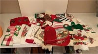 Assorted Christmas towels, oven mitts, and more