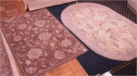 Two throw rugs: an oval hooked floral rug, 66"