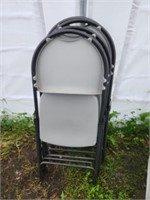 Four molded plastic metal frame folding chairs