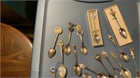 Assorted state collector spoons & display shelf
