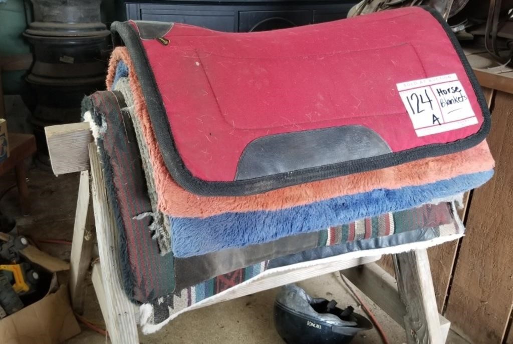 Stack of horse saddle pads, used