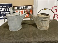 2 galvanized watering cans