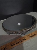 Beveled table mirror with ornate foots