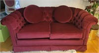 Upholstered burgundy love seat