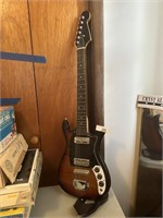 Electric guitar with strap