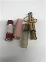 Group of lipstick holders and perfume bottle