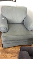 Blue over stuffed arm chair with arm covers,