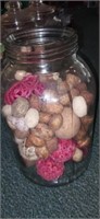 Large glass jar filled with potpourri