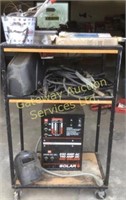 Solar arc welder with helmets, rods, cables, and