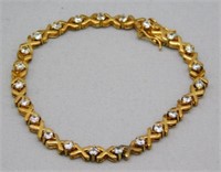 7" GOLD OVER SILVER BRACELET WITH WHITE TOPAZ.