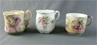 Group of Three Porcelain Mustache Cups