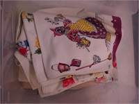Container of 15 colorful vintage tablecloths