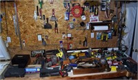 Tools and supplies on work bench and wall; as is