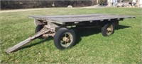 Old 14'X7' hay wagon on spoke wheels.