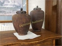 TWO DIFFERENT SIZED RUSTIC LIDDED URNS